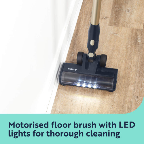Motorised floor brush with LED lights cleaning along a skirting board