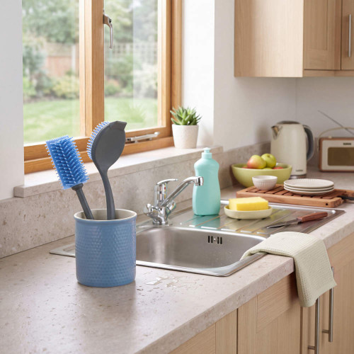 Blue kitchen sink brush set in holder by a sink