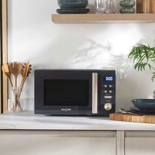 Grey microwave oven with digital display on kitchen worktop
