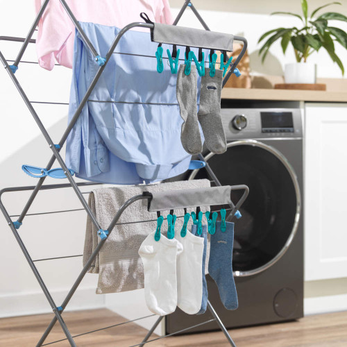 Grey organiser with pegs holding two grey and two white socks on a washing line