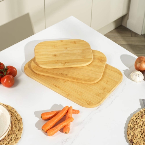 Set of three rectangular bamboo chopping boards on a kitchen worktop