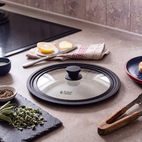 Russell Hobbs glass saucepan lid with black handle on kitchen worktop