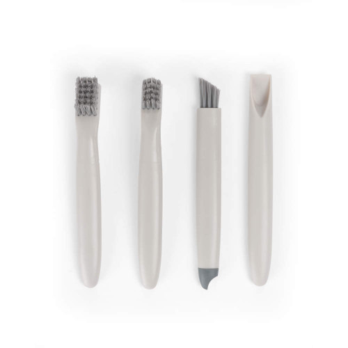 Set of four grey cleaning brushes and tools for small spaces.