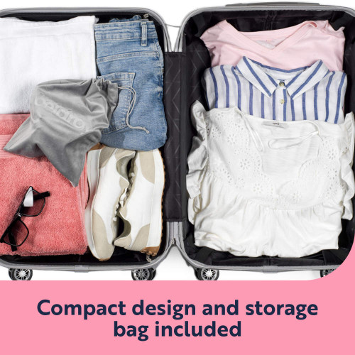 Open suitcase packed with folded clothes, trainers and storage bag included