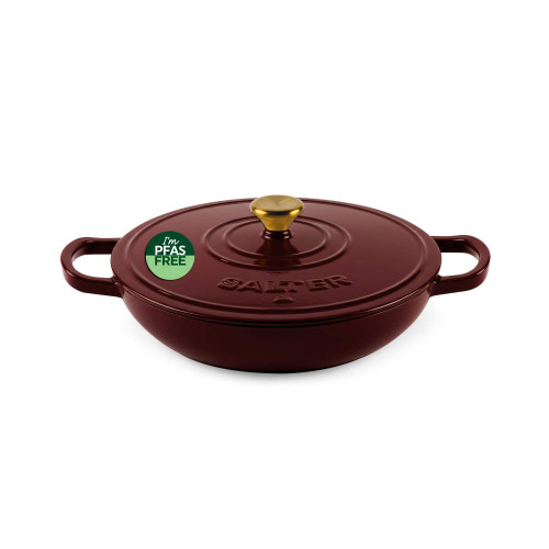 Red casserole dish with lid, gold handle and PFAS free label, shown from above.
