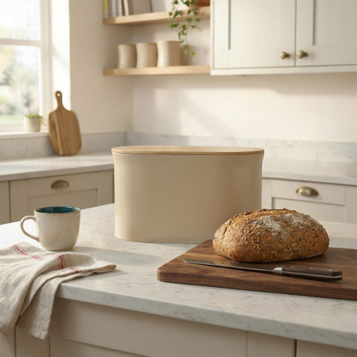Beige bread bin with wooden lid on kitchen counter, loaf and knife in foreground