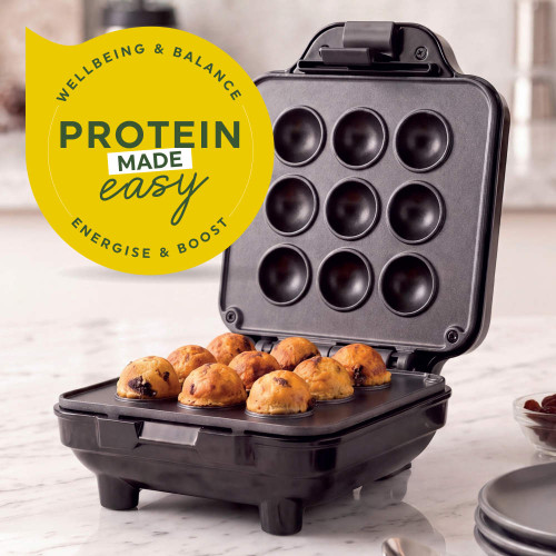 Open black cake pop maker with nine baked bites and 'Protein made easy' graphic