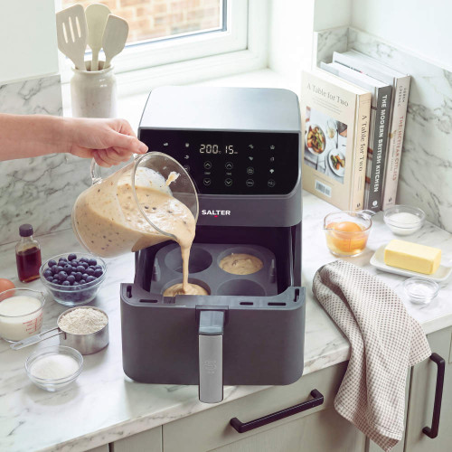 Grey Salter air fryer with muffin tray being filled with batter