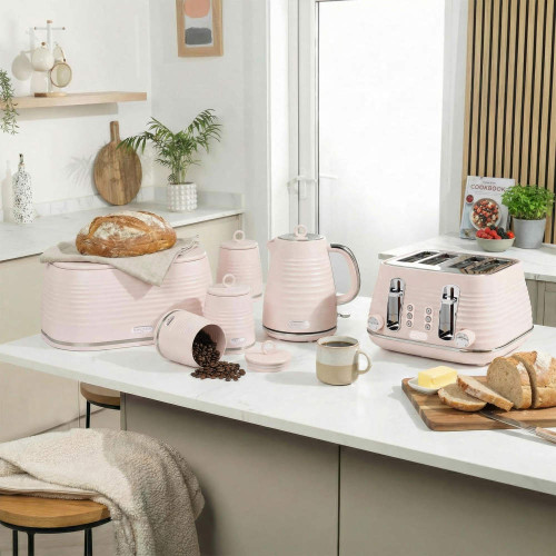 Pink kitchen set with toaster, kettle, bread bin and canisters on countertop