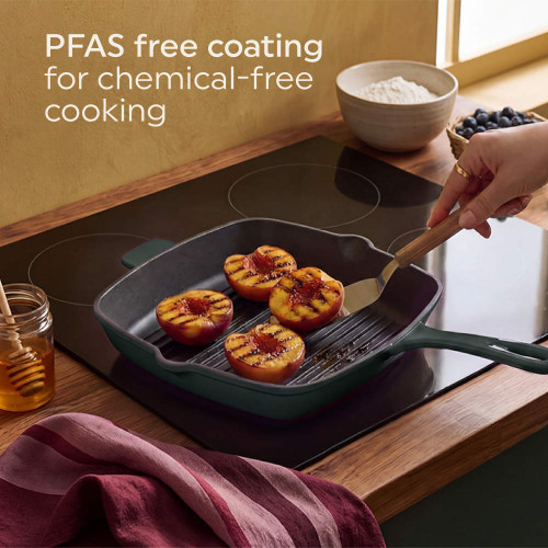Green griddle pan with grilled peaches on induction hob, promoting PFAS free coating