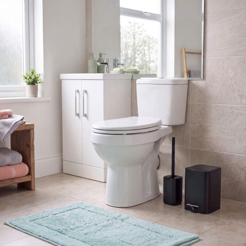 White close-coupled toilet in modern bathroom