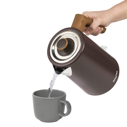 Brown electric kettle pouring hot water into a grey mug