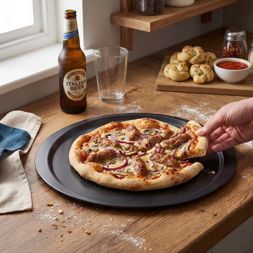 Hand taking slice of chicken and onion pizza on tray in kitchen setting