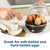 Black egg cooker with six eggs and lid lifted, for soft-boiled and hard-boiled eggs