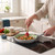 Non-stick frying pan cooking vegetables and prawns on induction hob