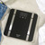 Black digital bathroom scale with large display and metallic accents