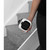 White portable ceramic heater held by person on carpeted stairs