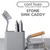 Stone grey sink caddy set with washing up brush, scrubbing brush, and sponges.