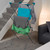 Freestanding indoor clothes airer holding assorted shirts and tops in lounge setting