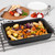 Roasting tin with cooked mixed vegetables on a kitchen worktop