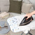White ironing board with abstract pattern stored under staircase
