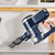 Cordless handheld vacuum cleaning crumbs from a tabletop