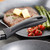 Close-up of grill pan with steak, asparagus and tomatoes, showing non-stick handle