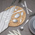 Silver cutlery set arranged on placemat and grey table with striped napkin and plates