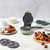 Green waffle and doughnut maker with interchangeable plates, shown with cooked treats.