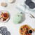 Green mini waffle and doughnut maker with fresh waffles and doughnuts, top view