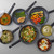Set of non-stick frying pans with assorted cooked dishes, top-down view
