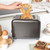 Two-slice gunmetal toaster with dial and buttons on a kitchen counter