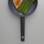 Non-stick frying pan with black handle, shown with chicken breast and asparagus
