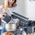 Salter black stand mixer with metal bowl in kitchen, ingredients beside.