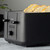 Black 4-slice toaster with controls, showing toasted bread