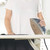 Person ironing black garment with gold and navy Beldray steam iron on board