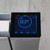 Close-up of white digital radiator with illuminated control panel display