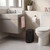 Black pedal bathroom bin beside toilet in modern bathroom