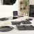 Set of black speckled non-stick baking trays and tins displayed in a kitchen