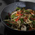 Vegetable stir fry in a non-stick wok, showing colourful fresh ingredients.