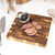 Meat thermometer showing temperature in cooked beef joint on wooden board