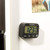 Black Salter digital kitchen timer with three buttons, shown on a fridge door