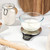 Glass bowl of milk on Salter digital kitchen scale, baking ingredients nearby