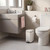 White rectangular pedal bin in modern bathroom, positioned beside toilet