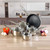Set of four stainless steel saucepans and a frying pan on kitchen counter