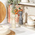 Set of cream and grey Salter salt and pepper mills on kitchen shelf