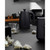 Black electric kettle on kitchen counter with glass cup and tea bags