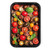 Roasted mixed tomatoes with herbs and basil leaves in a black oven tray