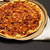 Round pepperoni pizza on a gold Russell Hobbs baking tray.