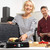 Contact grill cooking two chicken breasts and a steak on speckled grill plate